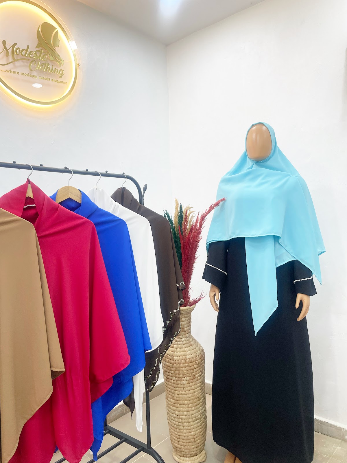 Modeste sky blue wrap draped over classic black abaya