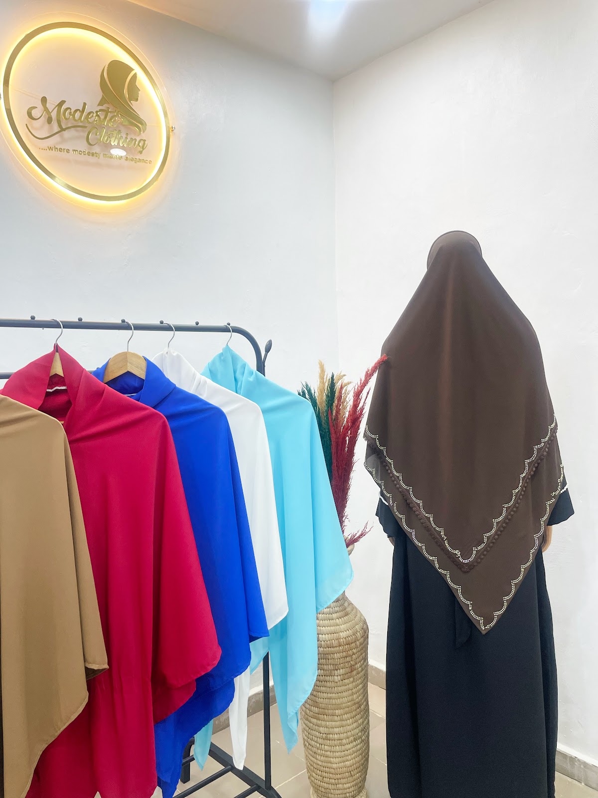 Modeste chocolate brown scalloped wrap draped over black abaya